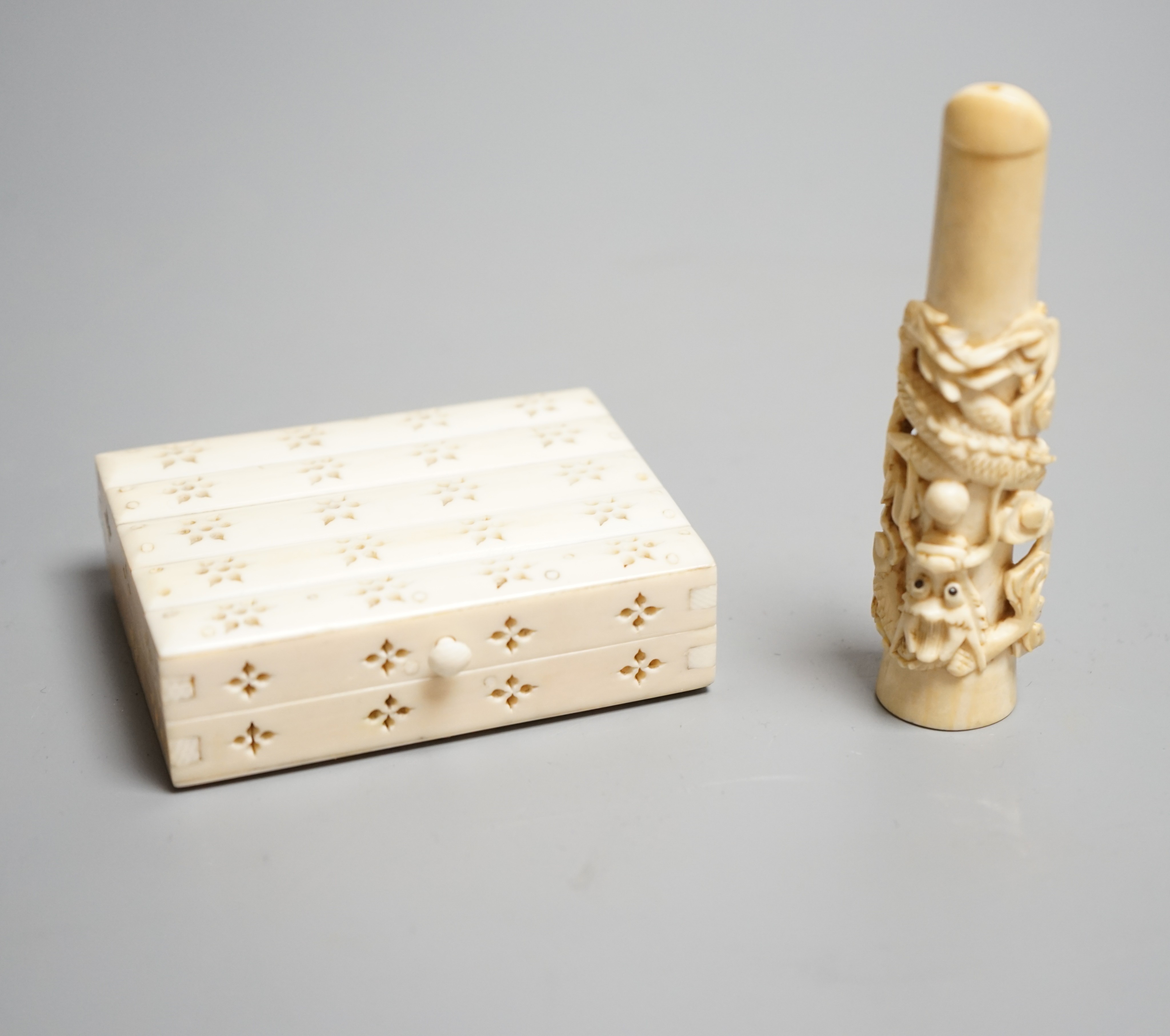 A Chinese ivory cigarette case, 8 x 6cm, and a Chinese carved ivory cheroot holder